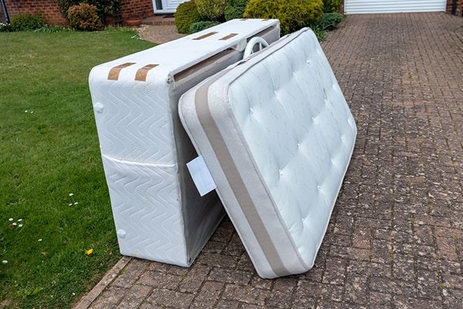 men disposing of old mattress